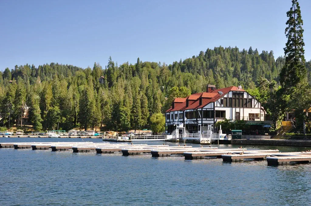 A long line of boat slips in the water in front of a vacation lodge at Lake Tahoe
