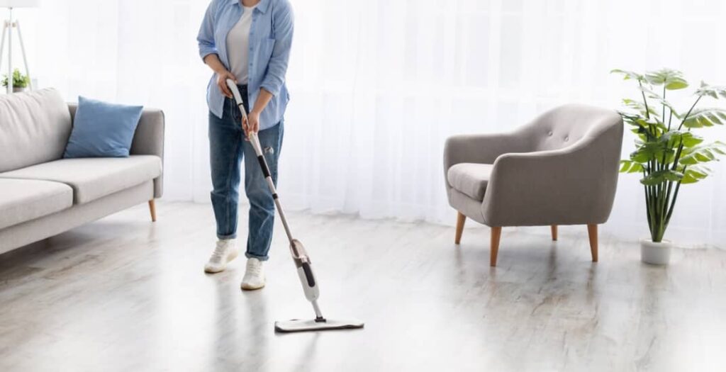 woman cleaning floor with spray mop