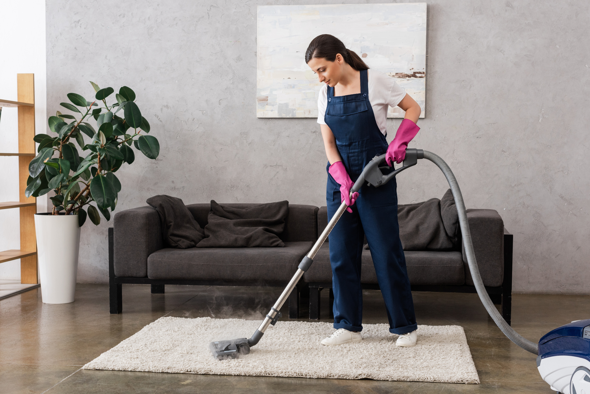 professional cleaner vacuuming carpet