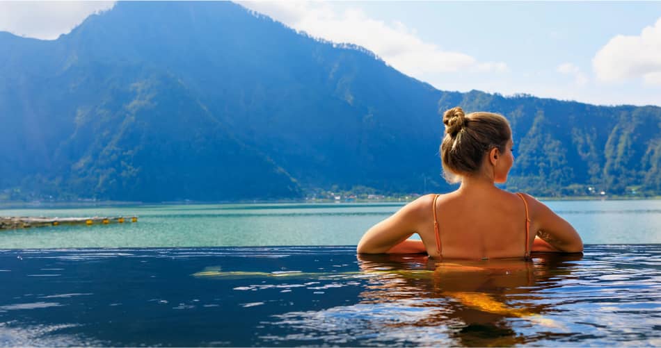 img - young-woman-relax-infinity-pool-lake-view-natural-hot-spring